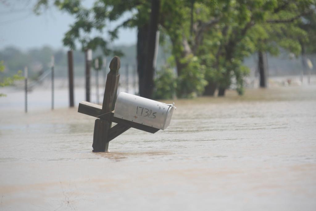 A mailbox is partially submerged on a flooded street in an unincorporated area in east Harris County near Houston 