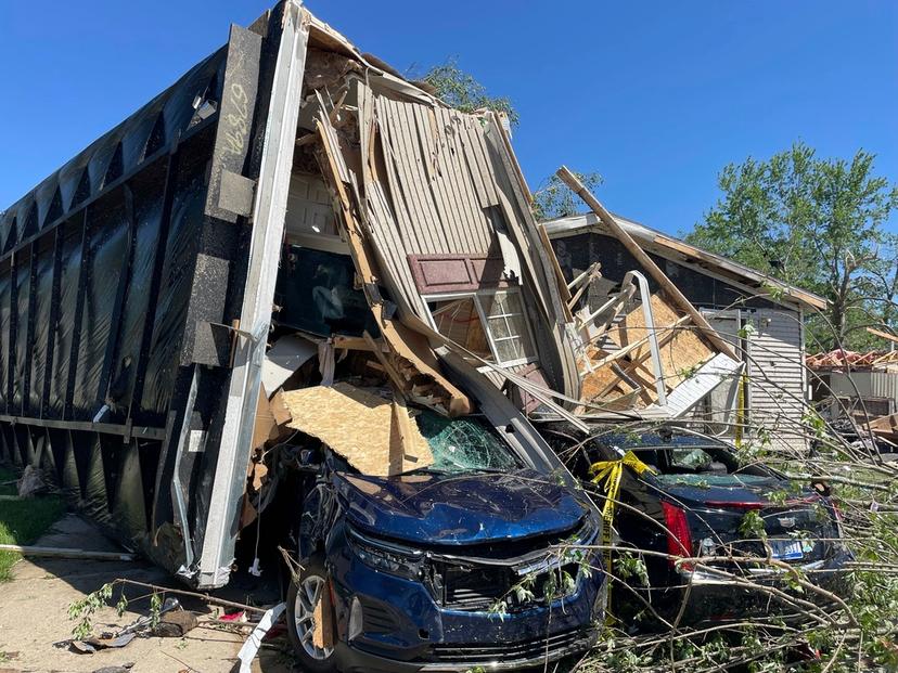 A mobile park home flipped onto two nearby cars after a tornado struck Pavilion Estates near Kalamazoo, Mich.