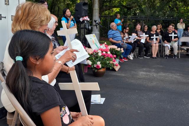 Mourners pray during a memorial vigil at The Farmworkers Association in Apopka, Fla. 