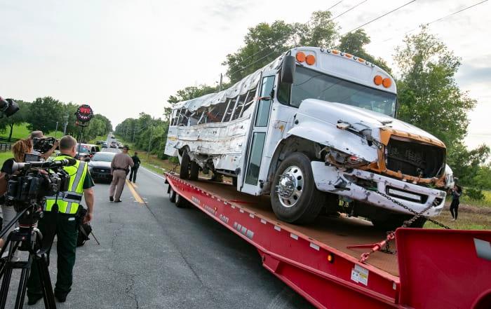 A bus is removed after it collied with a small pickup truck
