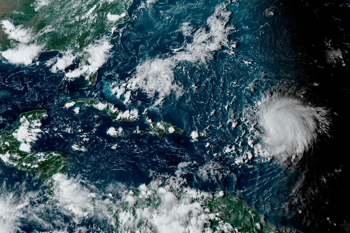 This satellite image provided by the National Oceanographic and Atmospheric Administration shows Hurricane Lee, right, in the Atlantic Ocean on Friday, Sept. 8, 2023, at 4:50 p.m. EDT. 