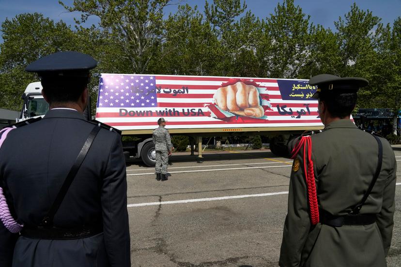 An anti-U.S. banner is carried on a truck during Army Day parade at a military base in northern Tehran, Iran