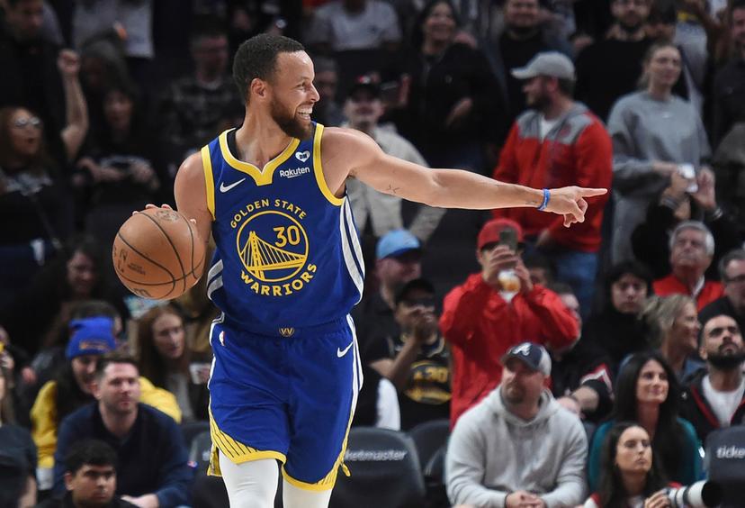 Golden State Warriors guard Stephen Curry smiles, at the end of the team's NBA basketball game against the Portland Trail Blazers