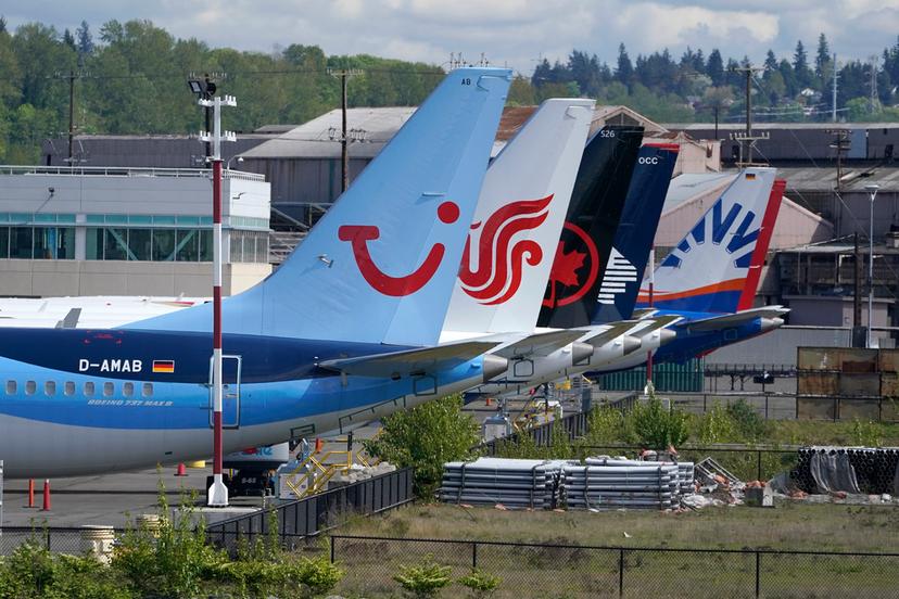 Boeing 737 Max airplanes, including one belonging to TUI Group, left, sit parked at a storage lot, Monday, April 26, 2021, near Boeing Field in Seattle. Boeing reports earnings on Wednesday, April 24, 2024.