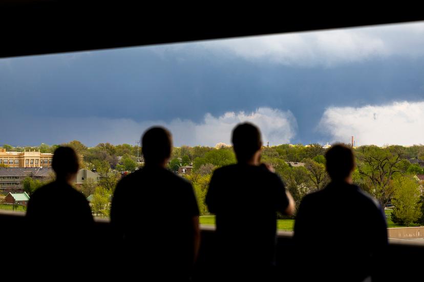 From left; Ally Mercer, Gabe Sedlacek Kaleb Andersen and Austin Young watch a tornado from a seventh floor parking garage in Lincoln, Neb. 