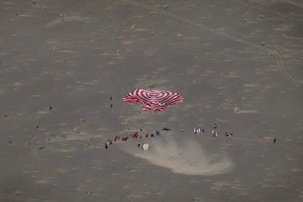 In this photo released by Xinhua News Agency, the capsule of Shenzhou-17 manned spaceship carrying astronauts Tang Hongbo, Tang Shengjie and Jiang Xinlin touches down at the Dongfeng landing site in north China's Inner Mongolia Autonomous Region