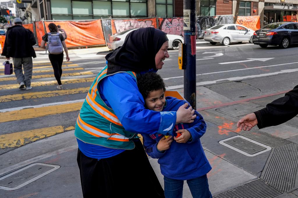 Tatiana Alabsi, left, hugs her nephew Adam Khalid as she roams the Tenderloin neighborhood 