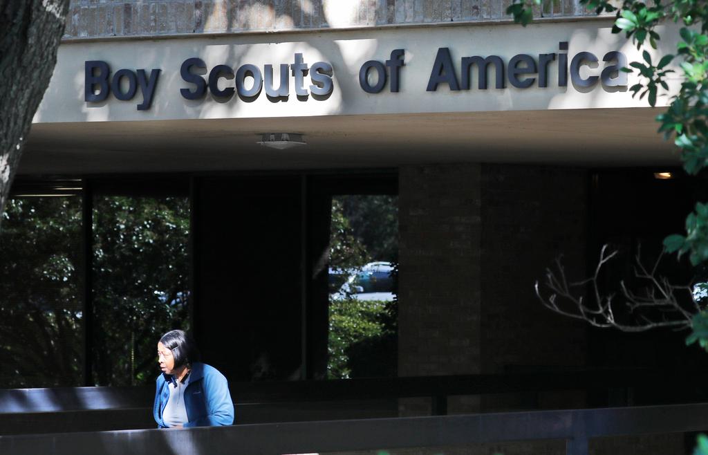 A woman walks out of the Boy Scouts of America national headquarters building in Irving, Texas, Nov. 1, 2019.