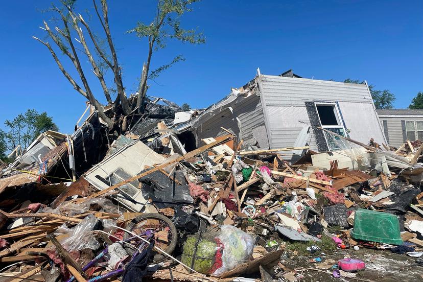 A storm damaged mobile home is surrounded by debris at Pavilion Estates mobile home park just east of Kalamazoo, Mich.
