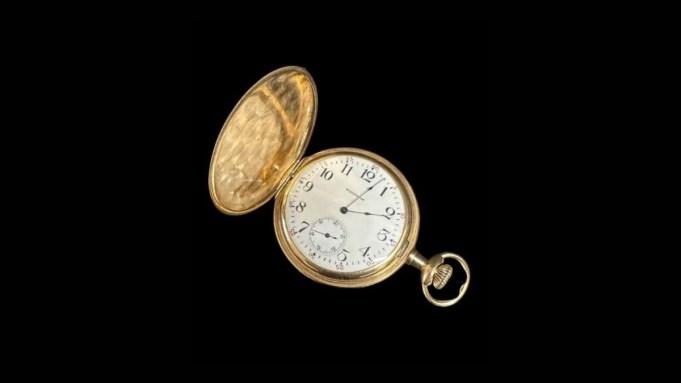 Gold pocket watch, open. Shows 2pm.