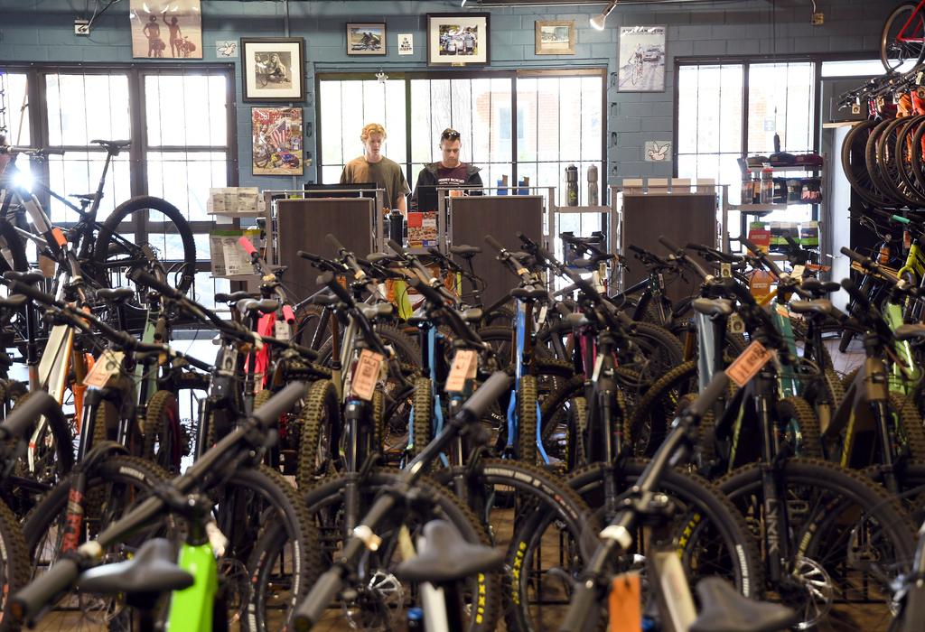 Salesmen Will Malfeld, left, and Ben Chandler, right, work at University Bicycles in Boulder, Colo.