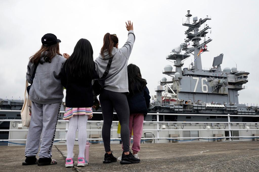 Family members of the crew of the U.S. navy aircraft carriers USS Ronald Reagan (CVN-76) see off at the U.S. navy's Yokosuka base Thursday, May 16, 2024