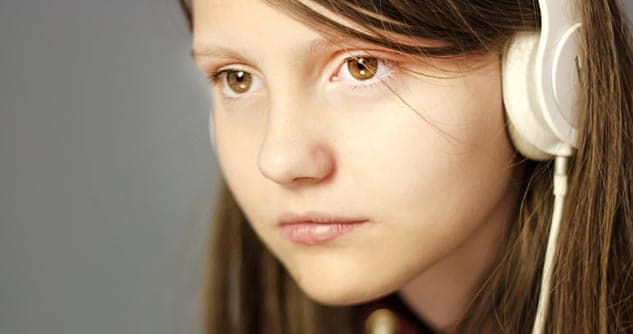 Sad girl, brown eyes, wearing white headphones