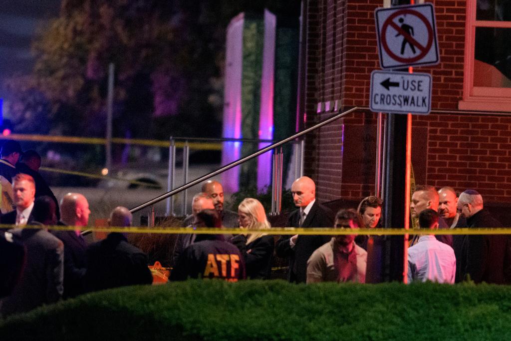 Attorney General Pam Bondi, center, as law enforcement work the scene after two staff members of the Israeli Embassy in Washington were shot and killed outside the Capital Jewish Museum
