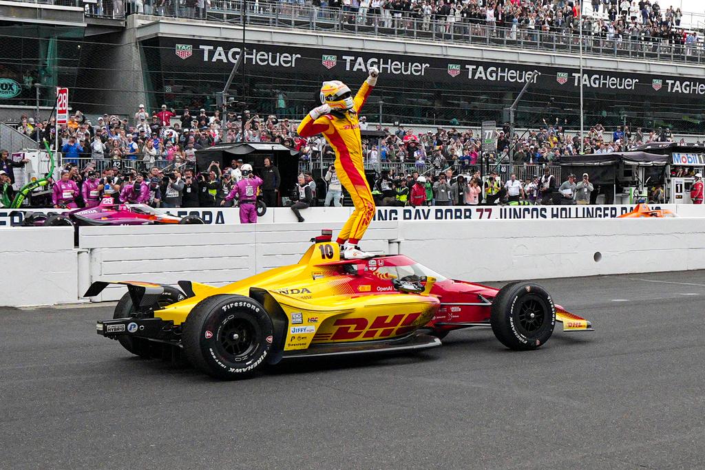 Alex Palou, of Spain, celebrates after winning the Indianapolis 500 
