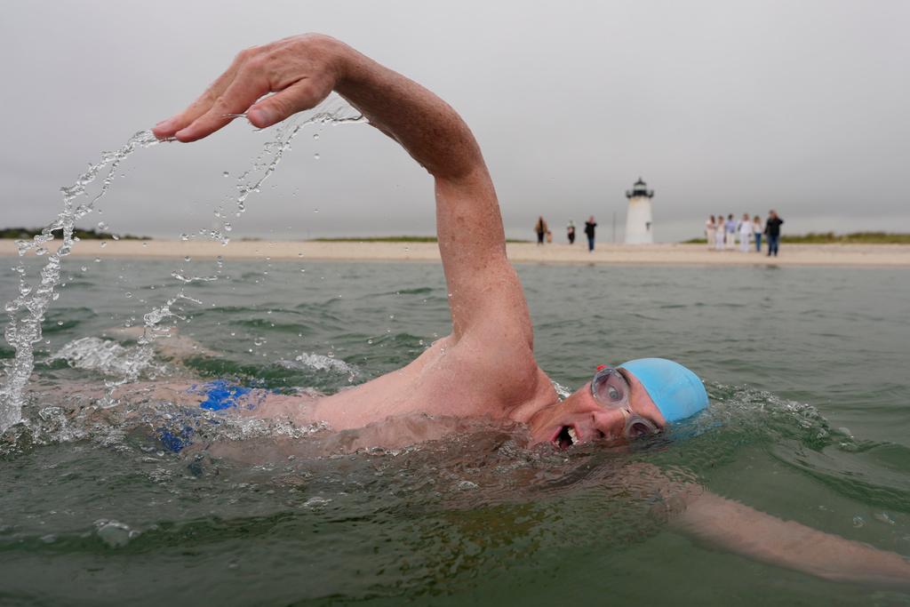 Endurance swimmer Lewis Pugh swims near the Edgartown Harbor Light in Edgartown, Mass. 