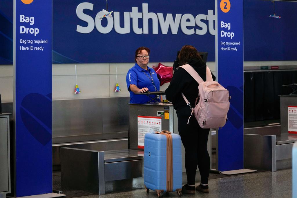 Southwest Airlines traveler checks a bag at Midway International Airport