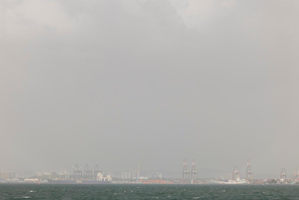 Ships sit in the Port of San Juan, Puerto Rico, as a cloud of dust from the Sahara Desert blankets most of the Caribbean