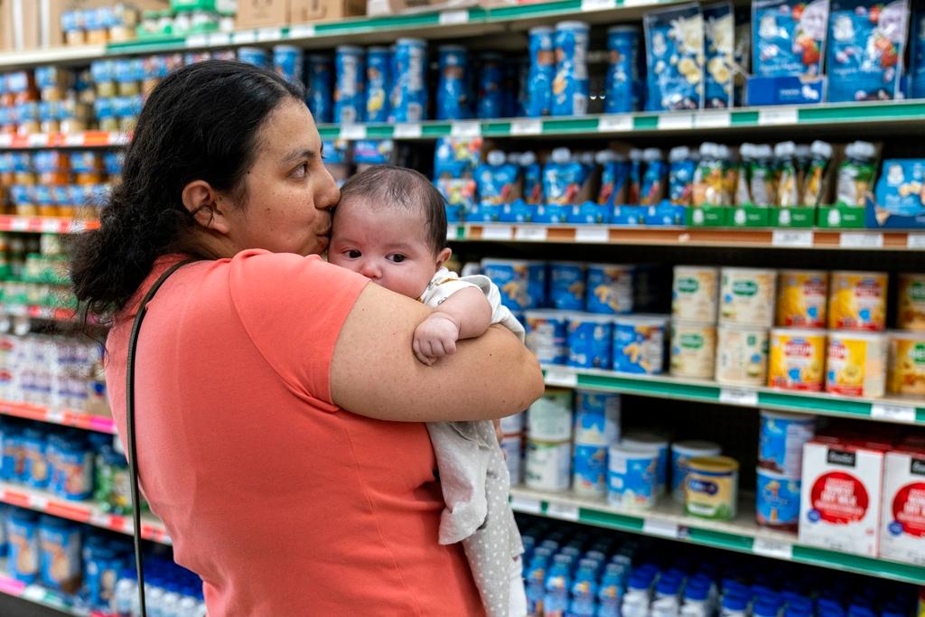 Yury Navas, 29, of Laurel, Md., kisses her two-month-old baby Jose Ismael Gálvez, at Superbest International Market in Laurel, Md.