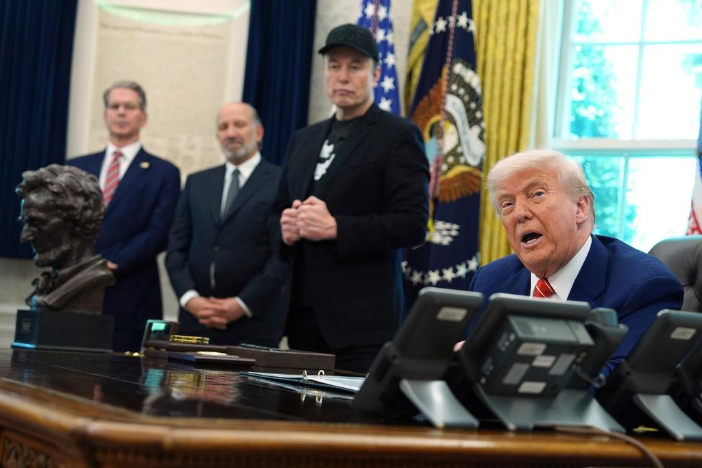 President Donald Trump, from right, speaks during a news conference with Elon Musk as Commerce Secretary Howard Lutnick and Treasury Secretary Scott Bessent listen in the Oval Office of the White House, Friday, May 30,