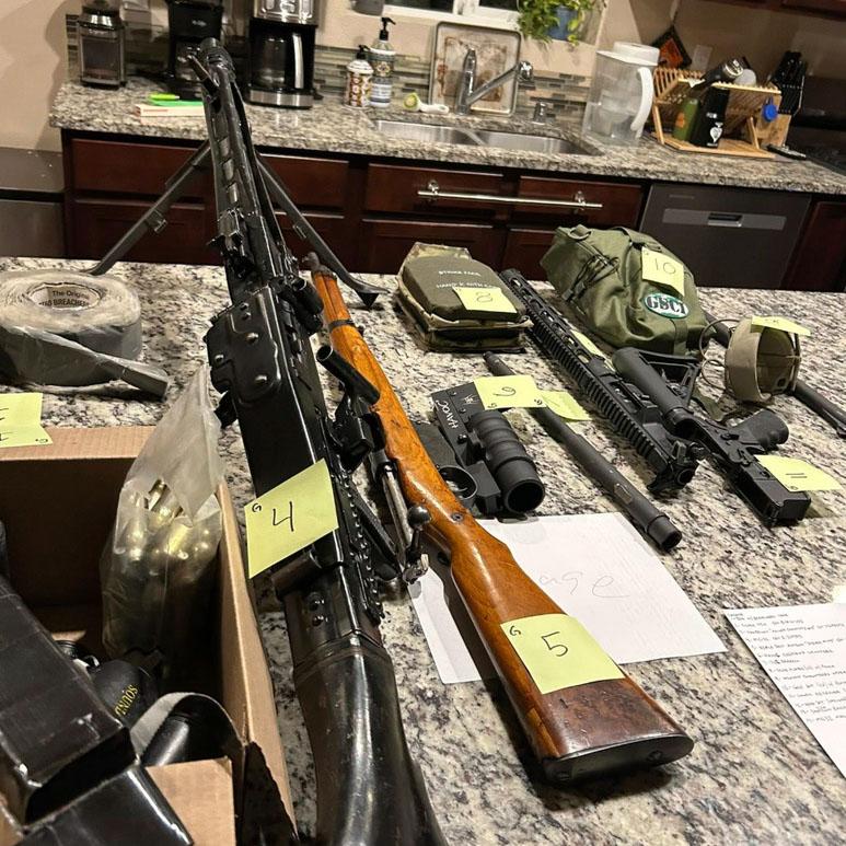 Cache of military weaponry is displayed during a raid at a home in Lacey, Wash. 