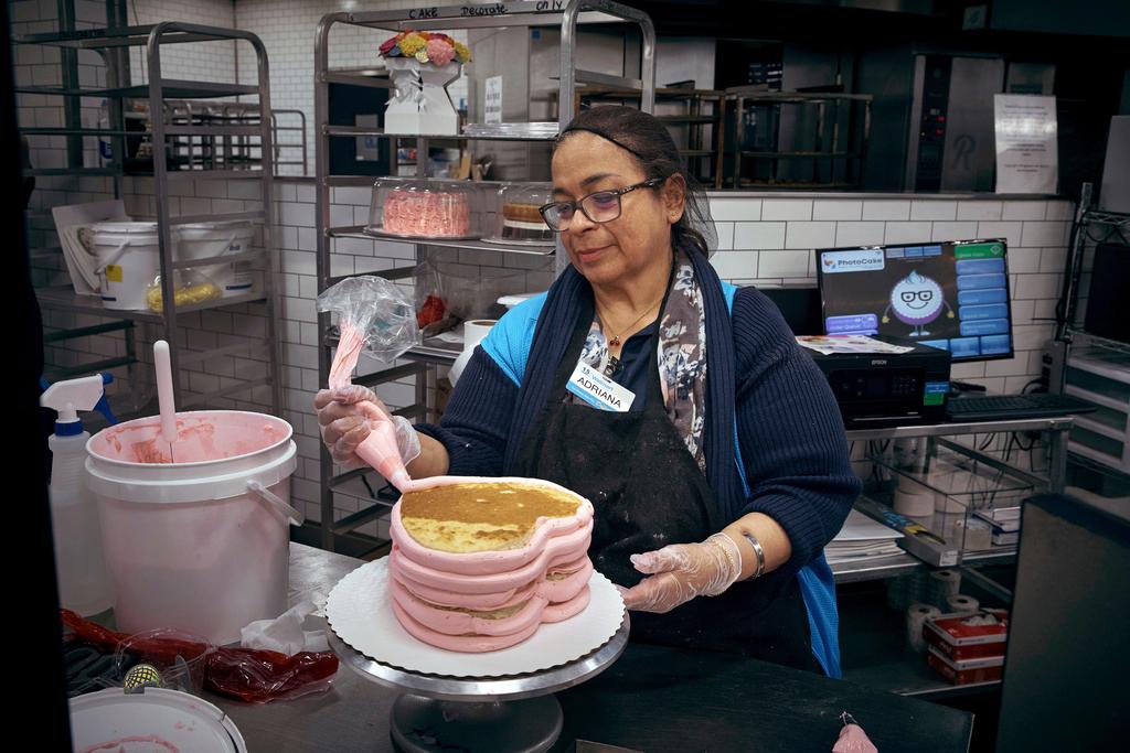 Adriana completes a cake inside Walmart Supercenter in North Bergen, N.J. 