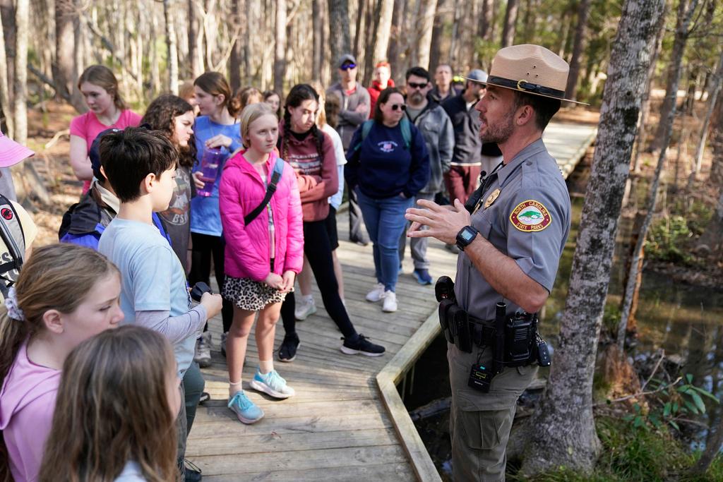 Park ranger Jesse Anderson speaks to visitors during a weekly carnivorous plant hike