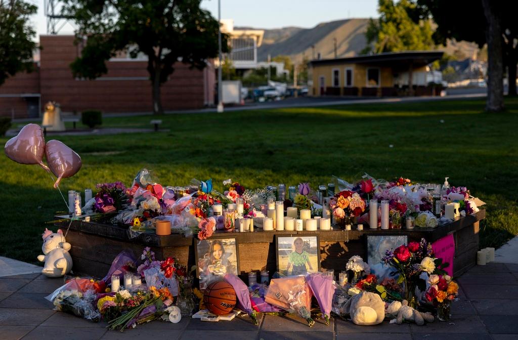 Pictures, flowers and candles mark a makeshift memorial in Wenatchee, Wash., in honor of Olivia, Paityn and Evelyn Decker, who were found dead near Leavenworth 