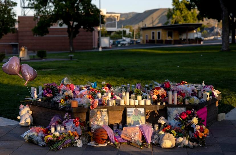 Pictures, flowers and candles mark a makeshift memorial in Wenatchee, Wash., in honor of Olivia, Paityn and Evelyn Decker, who were found dead near Leavenworth 