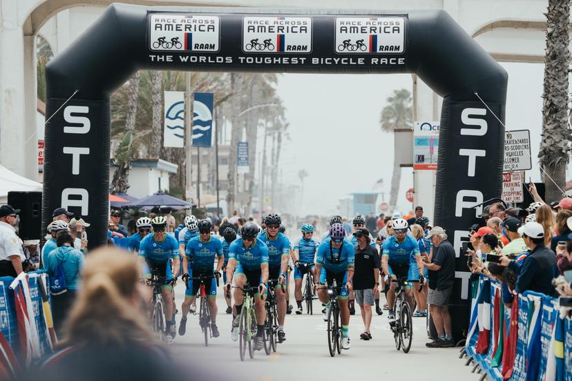 8 cyclists cross the start line as they begin the RAAM