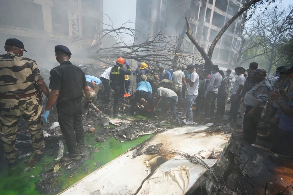 Rescuers work at the site of an airplane that crashed in India's northwestern city of Ahmedabad in Gujarat state