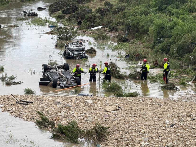 Authorities respond after vehicles were swept away by floodwaters in San Antonio