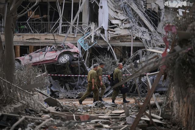 Israeli security forces inspect destroyed residential buildings that were hit by a missile fired from Iran, in Ramat Gan, near Tel Aviv