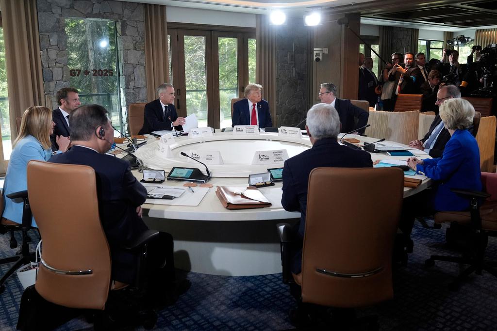 Italy's Prime Minister Giorgia Meloni, from left, France's President Emmanuel Macron, Canada's Prime Minister Mark Carney, President Donald Trump, Britain's Prime Minister Keir Starmer and Germany's Chancellor Friedrich Merz participate in a session of the G7 Summit in Kananaskis, Canada