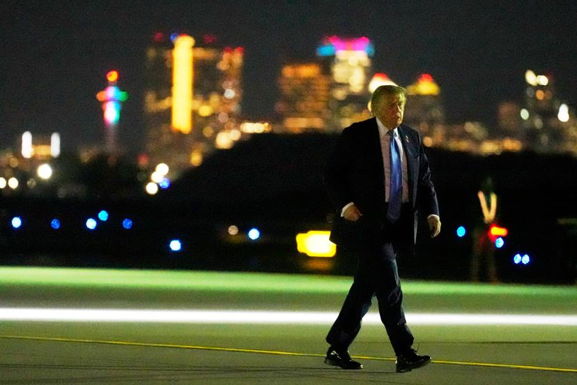 Downtown Calgary in the background, President Donald Trump walks from Marine One to board Air Force One at Calgary International Airport