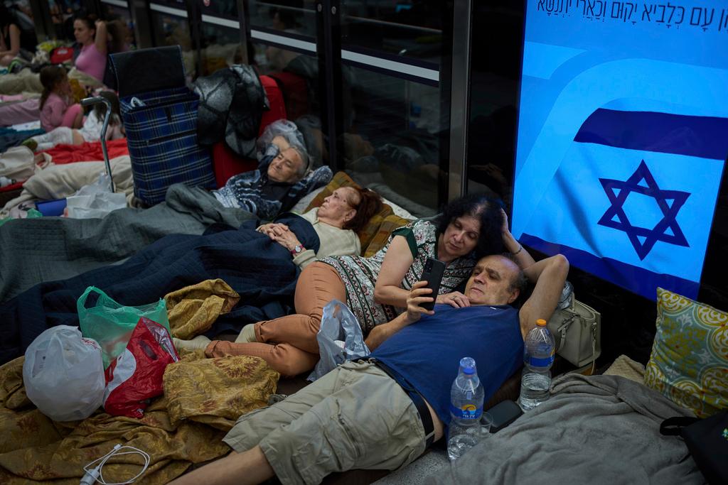 People take shelter in an underground metro station as a precaution against possible Iran missile attacks, in Ramat Gan, near Tel Aviv, Israel