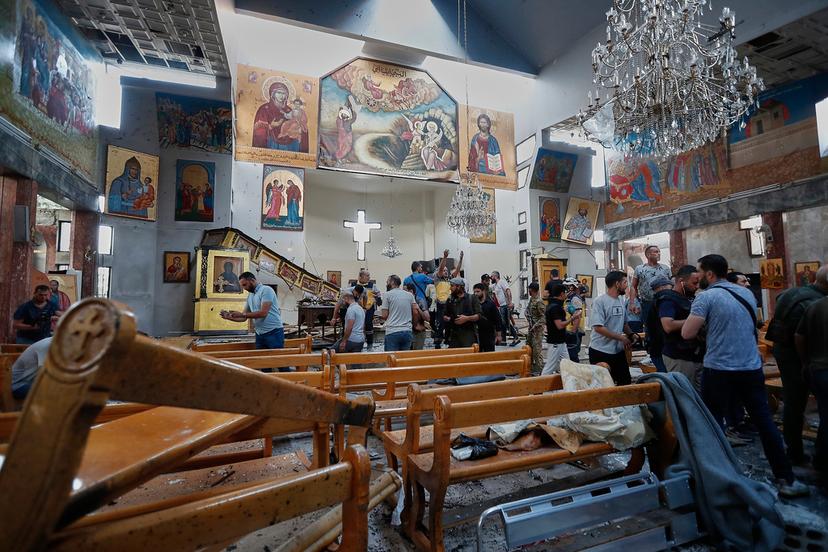 Journalists and Civil Defense workers inspect the damage inside Mar Elias church where a suicide bomber detonated himself in Dweil'a in the outskirts of Damascus, Syria