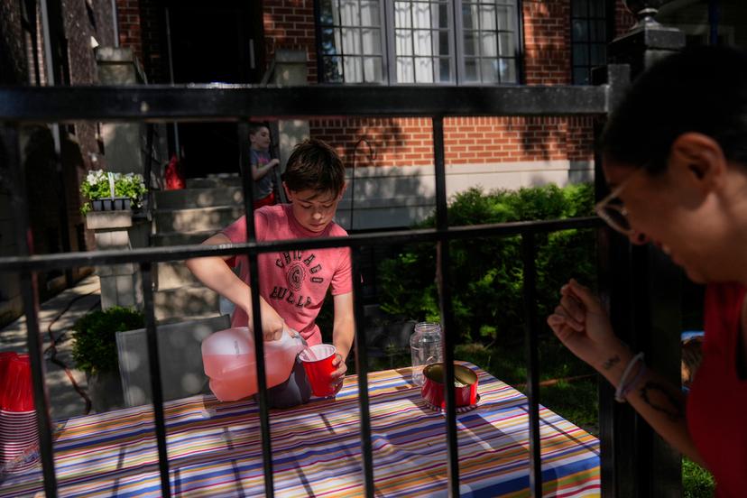 Robby, 12, sells lemonade in his front yard on a hot day in Chicago
