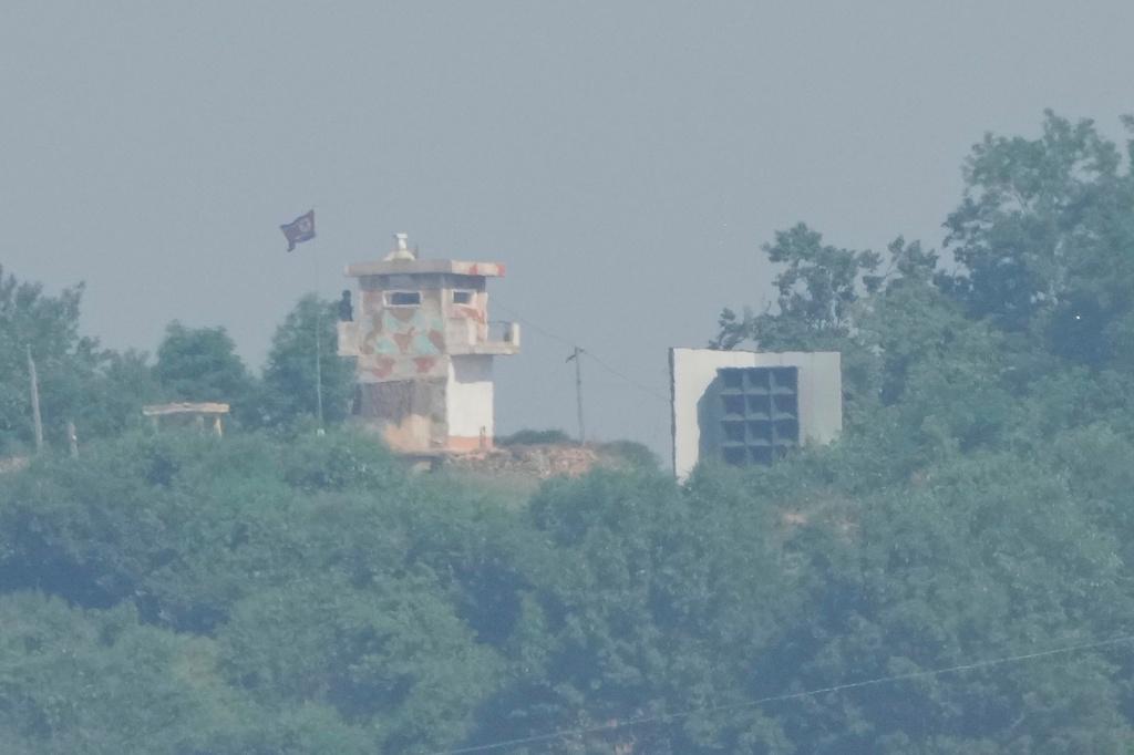 A North Korean military guard post, left, and loudspeaker are seen from Paju, South Korea