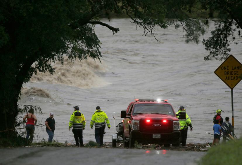 First responders scan the banks of the Guadalupe River for individuals swept away by flooding 