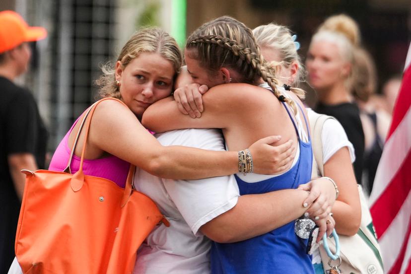 Campers embrace after arriving to a reunification area as girls from Camp Waldemar, near the North fork of the Guadalupe River, are reconnected with their families