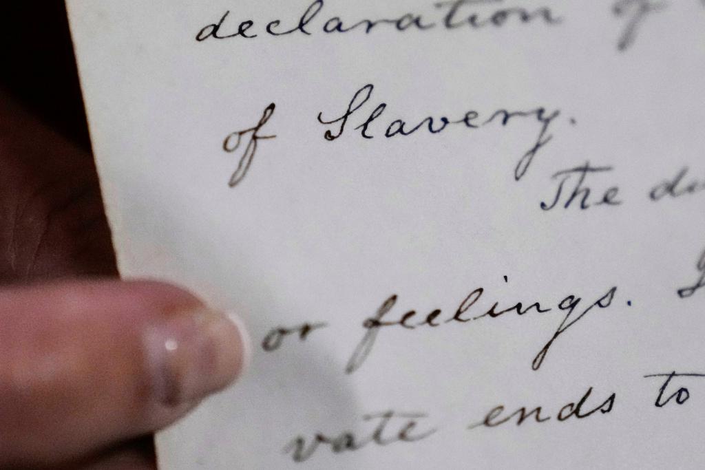 Historian Jennifer Cromack points out the word "Slavery" on a recently found, 178-year-old anti-slavery scroll at Grotonwood, the home mission of The American Baptist Churches of Massachusetts