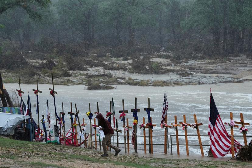 Rain falls over a makeshift memorial for flood victims along the Guadalupe River in Kerrville, Texas