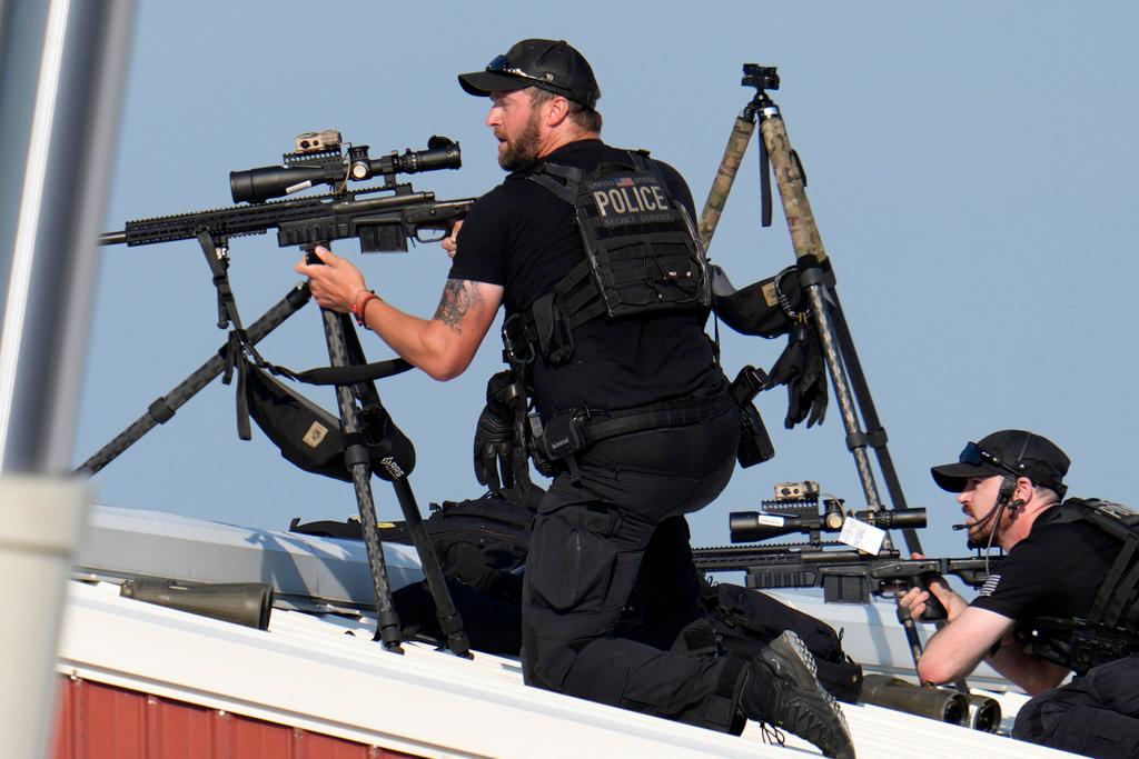 Police snipers return fire after shots were fired while Republican presidential candidate former President Donald Trump was speaking at a campaign event in Butler, Pa.