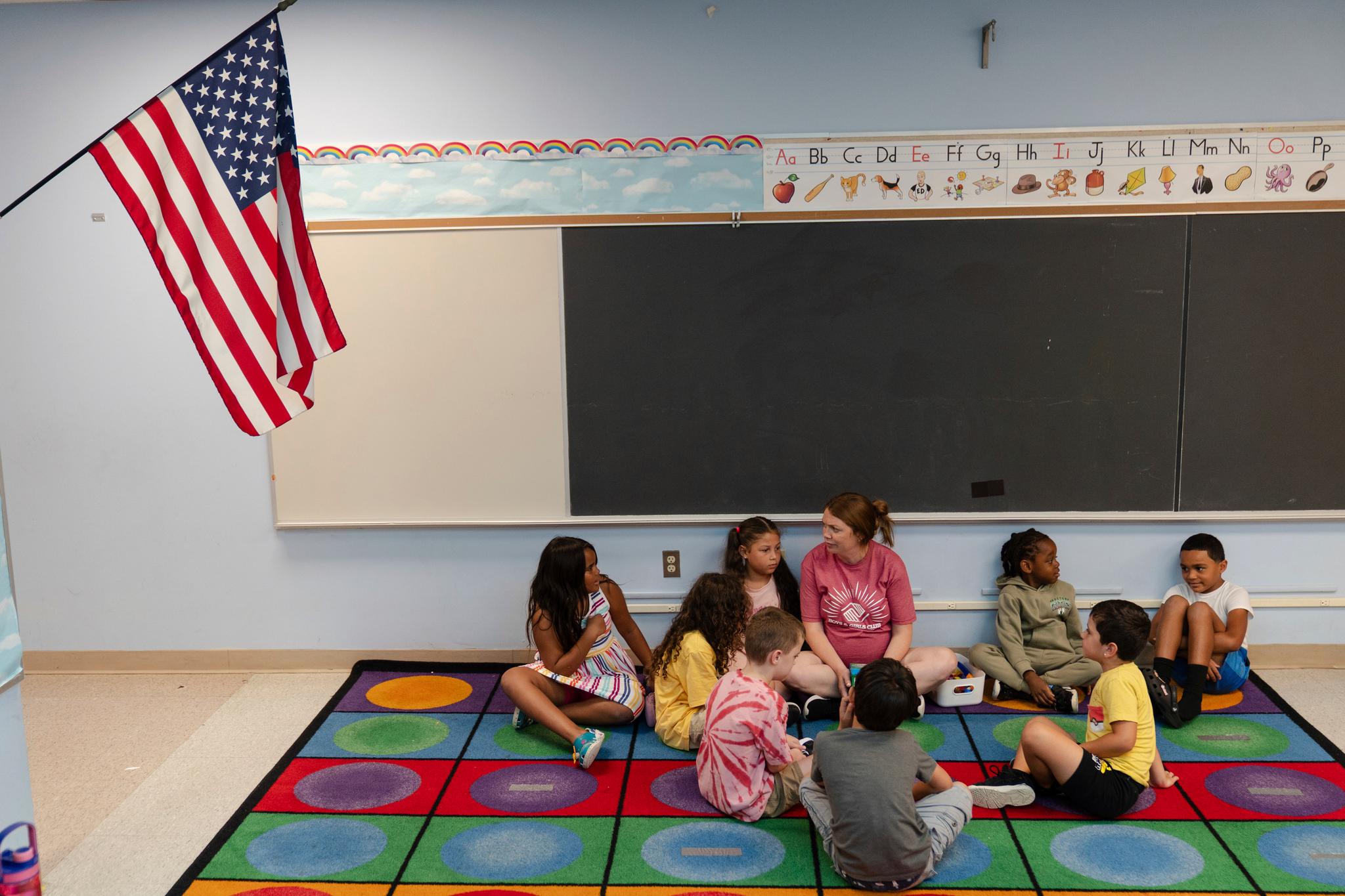 Children sitting on the floor in a classroom