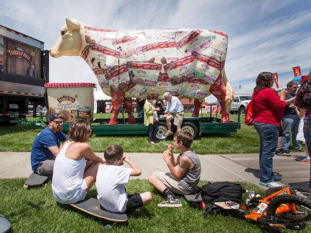 Giant Turkey Hill Cow looms over festival goers sampling ice cream at Taste of Omaha 