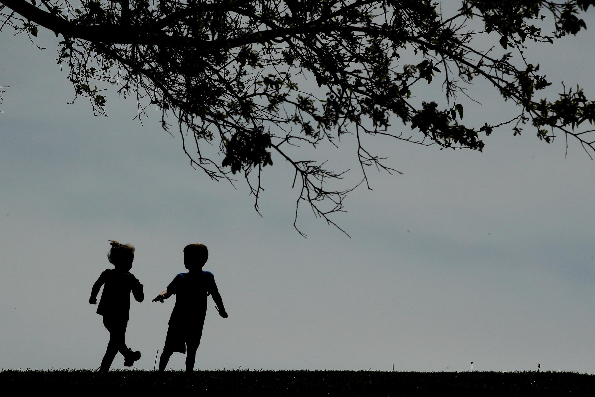Two small children playing outside