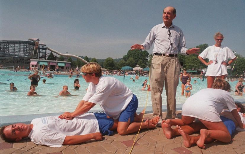Dr. Henry J. Heimlich uses lifegaurds at Coney Island swimming pool in suburban Cincinnati on Friday, July 9, 1999, to demonstrate how the Heimlich maneuver can help save people from drowning.