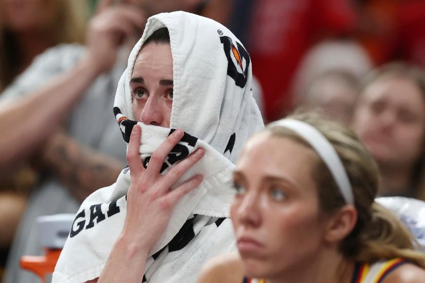 Indiana Fever's Caitlin Clark sits on the bench after an apparent injury during the second half of a WNBA basketball game against the Connecticut Sun, Tuesday, July 15