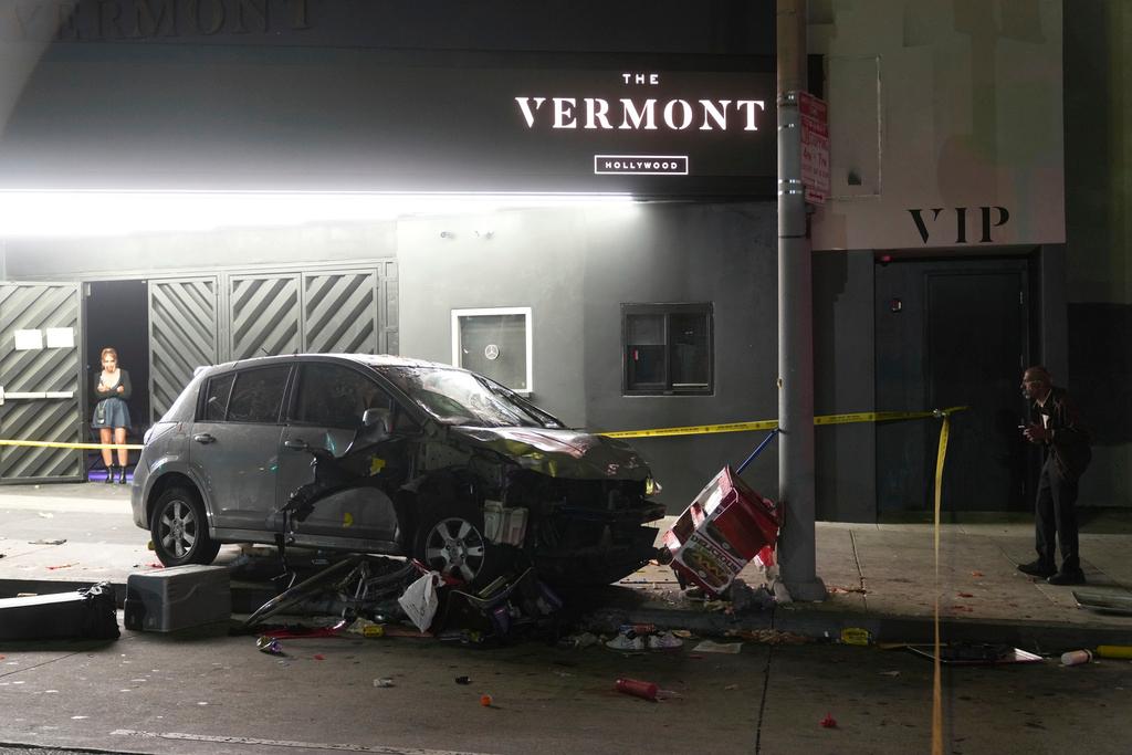 A vehicle sits on the sidewalk after ramming into a crowd of people waiting to enter a nightclub along a busy boulevard in Los Angeles 